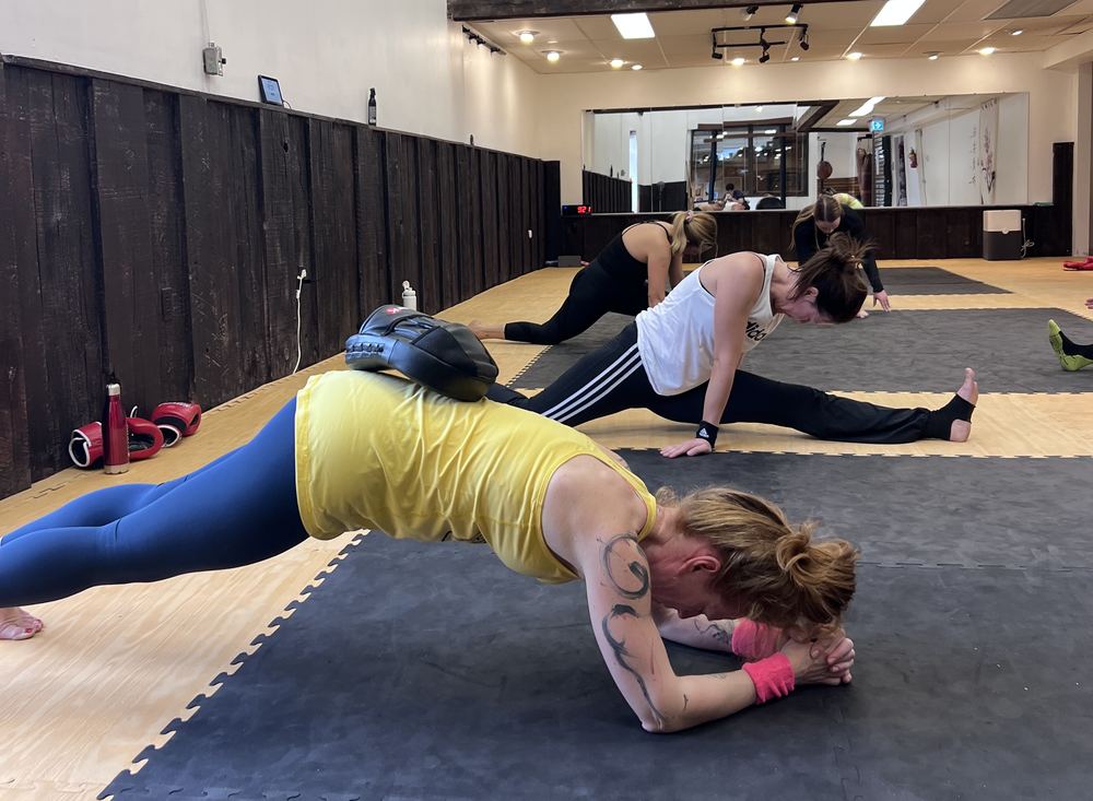 Members holding a plank on the mats